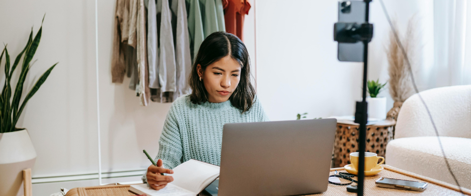 a woman is looking at her laptop and looks disappointed that the sponsored content dit not renew